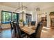 Elegantly designed dining room with a modern chandelier, large windows, and hardwood floors, perfect for entertaining at 18330 Archers Dr, Monument, CO 80132