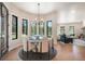 Bright dining area features a modern chandelier, a round table, and views of the trees at 18330 Archers Dr, Monument, CO 80132