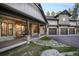 Charming home with stone accents, a welcoming front porch with rocking chairs, and a well-maintained lawn at 18330 Archers Dr, Monument, CO 80132