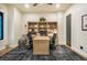 Stylish home office with custom built-in bookshelves and large desk, perfect for remote work at 18330 Archers Dr, Monument, CO 80132