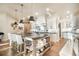 Charming kitchen features a large island with seating and modern white cabinetry at 18330 Archers Dr, Monument, CO 80132