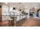 Modern kitchen with oversized island, white cabinets, barstool seating, and stainless steel appliances at 18330 Archers Dr, Monument, CO 80132