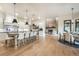 Bright, open-concept kitchen featuring a large island with seating and stainless steel appliances, flowing into the dining area at 18330 Archers Dr, Monument, CO 80132