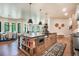 Open-concept kitchen and dining area with a large island, stainless steel appliances, and hardwood floors at 18330 Archers Dr, Monument, CO 80132