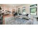 Inviting living room showcasing an open layout to the kitchen, stone fireplace, and bright natural light at 18330 Archers Dr, Monument, CO 80132