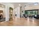 Inviting living room featuring a stone fireplace, hardwood floors, and seamless transition to the outdoors at 18330 Archers Dr, Monument, CO 80132