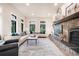 The spacious living room features bright, natural light and a stone fireplace at 18330 Archers Dr, Monument, CO 80132