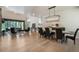 Spacious living and dining area with hardwood floors, stone fireplace, and backyard views at 18330 Archers Dr, Monument, CO 80132