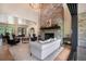Sophisticated living room with stone fireplace, hardwood floors, and abundant natural light at 18330 Archers Dr, Monument, CO 80132