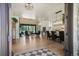 Open-concept living room and dining area with stone fireplace and large sliding doors to the backyard at 18330 Archers Dr, Monument, CO 80132