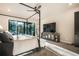 Comfortable main bedroom featuring a four-poster bed, TV, outdoor views, and modern decor at 18330 Archers Dr, Monument, CO 80132
