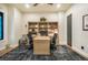 Cozy home office featuring a built-in bookcase, a comfortable desk, and a neutral color scheme for a productive workspace at 18330 Archers Dr, Monument, CO 80132