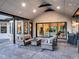 Inviting outdoor living space featuring stone accents, comfortable seating, and seamless indoor/outdoor flow with sliding glass doors at 18330 Archers Dr, Monument, CO 80132