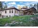 Expansive backyard featuring a patio, outdoor dining area, and lush green lawn, perfect for entertaining and relaxation at 18330 Archers Dr, Monument, CO 80132