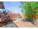 The backyard features a wood fence, mature tree, and a walkway to the alley at 3450 N Harrison St, Denver, CO 80205