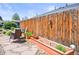 Backyard featuring a wooden fence, a seating area, and raised planting beds at 3450 N Harrison St, Denver, CO 80205