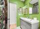 Bathroom showcasing a double vanity with floral wallpaper, and multiple framed wall art at 3450 N Harrison St, Denver, CO 80205