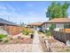 Charming single-story home featuring a landscaped front yard with stone details and a walkway leading to the entrance at 3450 N Harrison St, Denver, CO 80205