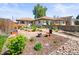Beautiful single-story home with a meticulously landscaped front yard featuring rock details, plants, and walkway at 3450 N Harrison St, Denver, CO 80205