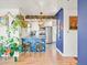 Bright kitchen featuring stainless steel appliances, white cabinets and blue accent wall with decor at 3450 N Harrison St, Denver, CO 80205