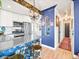 Stylish kitchen boasts stainless steel appliances, decorative wallpaper, and eye-catching blue accent wall at 3450 N Harrison St, Denver, CO 80205