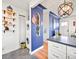 Open layout showcases the kitchen and laundry room with stainless appliances and custom shelving at 3450 N Harrison St, Denver, CO 80205