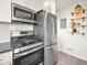Modern kitchen features stainless steel appliances, white cabinets and subway tile backsplash at 3450 N Harrison St, Denver, CO 80205