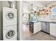 Open layout of the kitchen leads into the living room with stainless steel appliances and in-unit laundry at 3450 N Harrison St, Denver, CO 80205