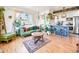 Bright living room featuring a green sofa, hardwood floors, and natural light at 3450 N Harrison St, Denver, CO 80205