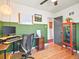 Office space with computer setup, red cabinet, green accent wall and light fixture at 3450 N Harrison St, Denver, CO 80205