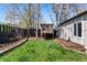 Well-maintained backyard features a charming playhouse and raised garden bed, perfect for outdoor enjoyment at 1065 Jackson St, Denver, CO 80206