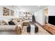 Finished basement with a comfortable sectional, modern shelving, and sleek design at 1065 Jackson St, Denver, CO 80206