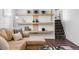 Finished basement featuring a comfortable sectional, modern shelving, and stylish decor at 1065 Jackson St, Denver, CO 80206