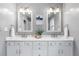 Elegant bathroom with double vanity, marble countertop, framed mirrors, and updated fixtures at 1065 Jackson St, Denver, CO 80206