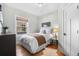 Bright bedroom with neutral decor, hardwood floors, and a large window offering natural light at 1065 Jackson St, Denver, CO 80206
