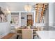 Dining room featuring a modern chandelier, a staircase, and seating for six at 1065 Jackson St, Denver, CO 80206