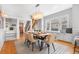 Staged dining room with a modern table, comfortable seating, and a view of the staircase at 1065 Jackson St, Denver, CO 80206