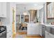 Bright, open kitchen with modern appliances, a view to the dining area, and hardwood floors at 1065 Jackson St, Denver, CO 80206