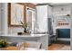 Modern kitchen features white cabinets, stainless steel appliances, and a view to the dining room at 1065 Jackson St, Denver, CO 80206