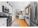 Modern kitchen showcases stainless steel appliances, white cabinets, and a dining area view at 1065 Jackson St, Denver, CO 80206