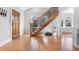 Bright living room featuring a staircase, hardwood floors, and a wooden front door at 1065 Jackson St, Denver, CO 80206