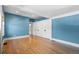Living room features hardwood floors, bright blue walls, and access to the hallway at 1065 Jackson St, Denver, CO 80206