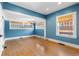 Bright living room features hardwood floors, blue walls, white trim, and plenty of windows at 1065 Jackson St, Denver, CO 80206