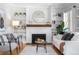 Bright living room featuring hardwood floors, a fireplace, and built-in bookshelves at 1065 Jackson St, Denver, CO 80206