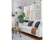 Bright living room with a white sofa, decorative pillows, and framed artwork at 1065 Jackson St, Denver, CO 80206