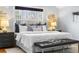 Main bedroom boasts a plush bed, accent wall decor, and a large window allowing natural light at 1065 Jackson St, Denver, CO 80206