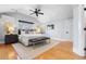 Spacious main bedroom with vaulted ceiling, plush bed, hardwood floors, and modern decor at 1065 Jackson St, Denver, CO 80206