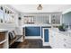Stylish mudroom features blue accent wall, built-in bench, shelving, basket storage and tiled floors at 1065 Jackson St, Denver, CO 80206