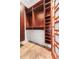 Spacious walk-in closet with custom wood shelving and storage, and a unique door at 1065 Jackson St, Denver, CO 80206