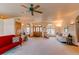 Bright living room with hardwood floors, a fireplace, and ample natural light at 886 Cherokee St, Strasburg, CO 80136